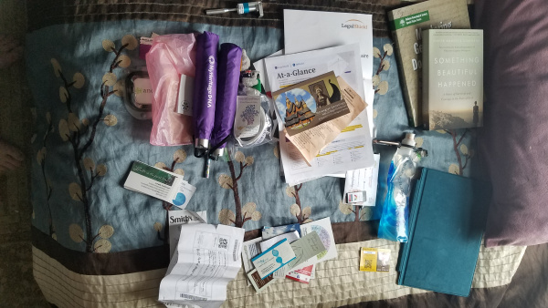 RootsTech 2018 - Unpacking from the trip - Conference stuff on bed - photo by Lorelle VanFossen