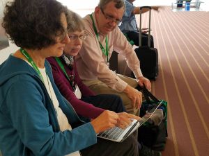 Genealogists helping each other on laptop during FGS conference 2017 - photo by Lorelle VanFossen